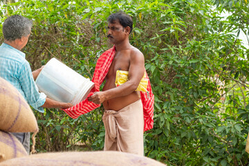 Rural people collecting ration from the ration distributor