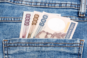Brazilian Cruzeiros in the pocket of blue jeans