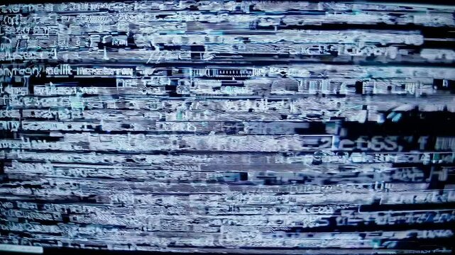 Close-up video of a computer screen displaying green text on a black background, angled slightly to the left, evoking a hacker theme. Live desktop wallpaper.