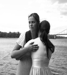 Insincere smile of a hugging girl