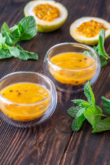 Passion Fruit Pulp in Glass Bowls on Rustic Wood