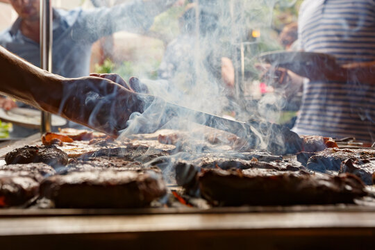 Sizzling barbecue at a vibrant outdoor gathering in a lively park during the warm summer afternoon