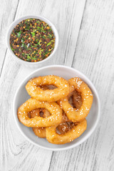 Crispy battered calamari rings with sesame seeds and spicy Asian dipping sauce