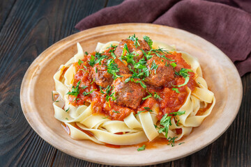 Beef meatballs with tomato sauce served over fresh tagliatelle pasta, Italian style