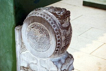 Detailed stone carving shows a dragon head and intricate patterns in The Summer Palace in Beijing,...