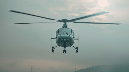 Helicopter in flight against a misty sky at sunrise.