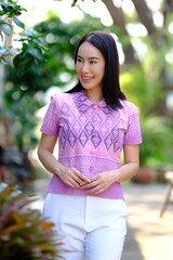 Pretty Asian women traveler in traditional Thai dress. Beautiful conventional Thai dresses Lanna style.