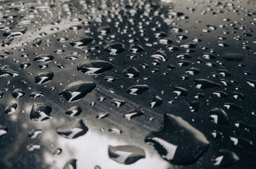 abstract background of water splash or water droplets on shiny black plate