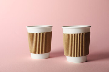 Paper cups on pink background. Mockup for design