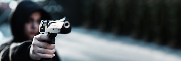 Female gangster, gun in hand, threatening, criminal