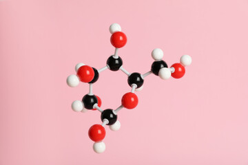 Molecule of glucose on pink background. Chemical model