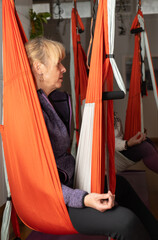 woman taking aerial yoga classes