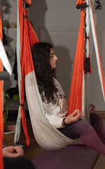 woman taking aerial yoga classes