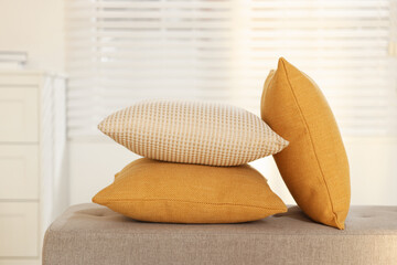 Soft decorative pillows on sofa in room