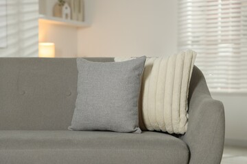 Soft decorative pillows on sofa in room