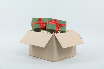 Parcel with gift boxes on light background