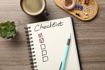 Checklist with marked checkboxes, coffee, plant and stationery on wooden table, flat lay