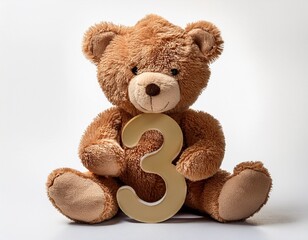 Obraz premium Cute brown teddy bear with number 3, kids third birthday party. Stuffed animal isolated on white background