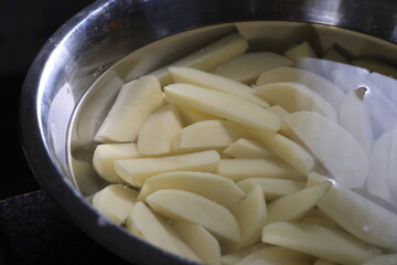 hand cut chips in a bowl with water