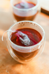 Red tea or called “ Dragon blood tea ” in the small clear glass
