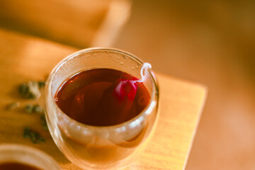 Red tea or called “ Dragon blood tea ” in the small clear glass