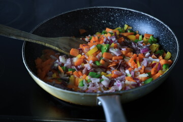 frying vegetables in a pan
