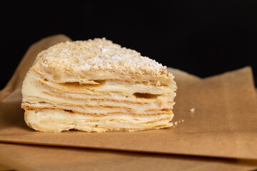 layered cake with white sweet cream on a board