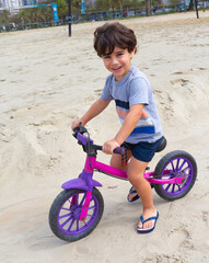 4 year old boy learning to ride a bike.