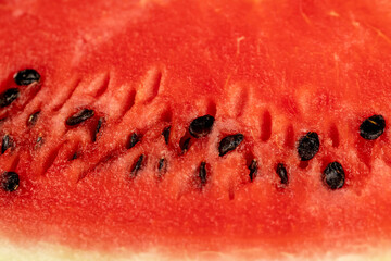 part of a sliced juicy watermelon with black seeds