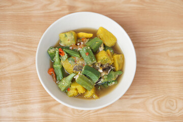 Bowl of curry mixed organic okra , pumpkin and Thai herbal ingredient. Concept, local food with nutrient. Healthy eating. High fiber and vitamin. Top view shot photo.