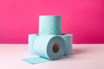 Blue toilet paper rolls on pink background