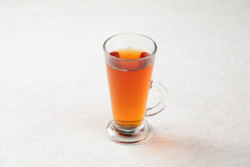 Glass mug of hot black tea