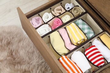 Organizers with folded clothes in drawer indoors, above view