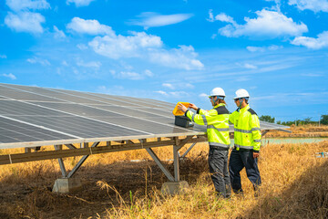Team engineers in a high visibility jacket performs an inspection on the underside of a solar panel...