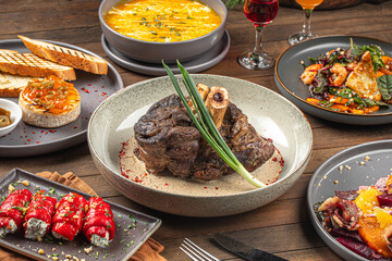 Portion of baked beef shank with pepper sauce on wooden table