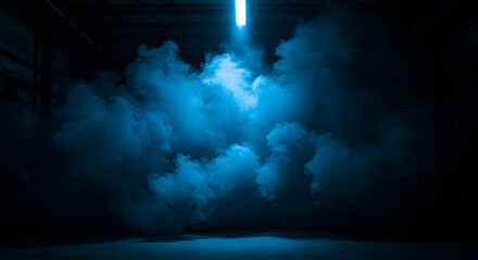 Dramatic blue smoke cloud illuminated by overhead fluorescent light in a dark industrial warehouse