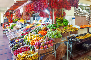 Colorful green market stall in Funchal, tropical fruits with and vegetables, vibrant local products...