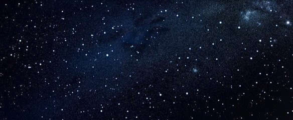 A deep blue backdrop filled with tiny white stars of equal size scattered throughout.