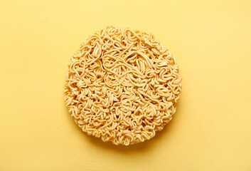 Raw instant noodles on yellow background