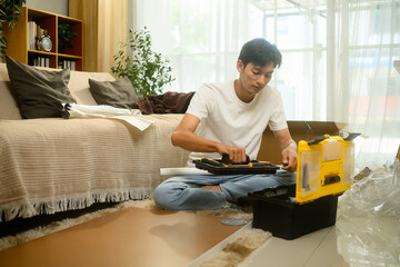 Young asian man checking the assembly guide before for new furniture