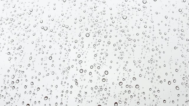 View from the window in rainy weather, raindrops on the window dripping down, autumn season, monsoon time, slow motion, 4K video
