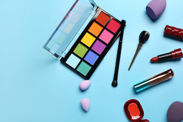 Different decorative cosmetics on blue background