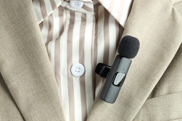 Woman with lavalier microphone on her shirt, closeup