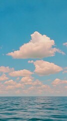 Serene seascape with fluffy clouds and calm ocean. Perfect for travel, nature, and relaxation themes.