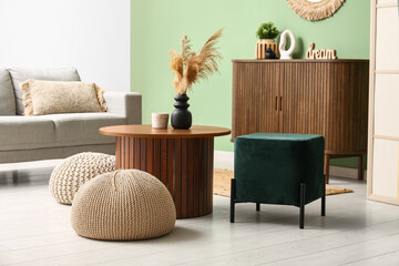 Interior of modern living room with coffee table and poufs