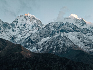 Rocky foreground and mountain peaks under clear sky