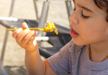 4 year old boy eating boiled corn