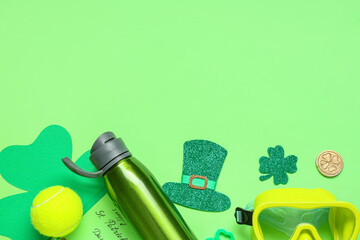 Diving mask, water bottle, tennis ball and decorations for St. Patrick's Day celebration on green...