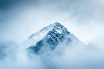 Mountain peak emerging from fog with dramatic perspective and negative space
