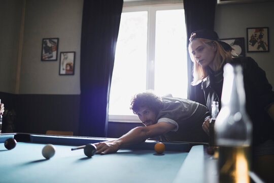 Young people playing pool in a club